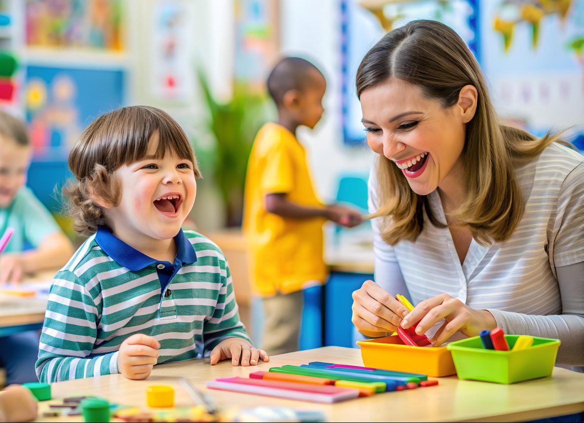 A classroom scene where an adult and a child sit together at a table working with coloured pencils and craft materials.